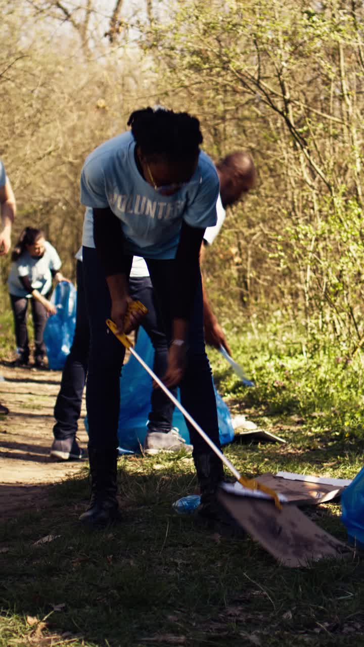 Young Woman Volunteer Picking Up Litter in a Park