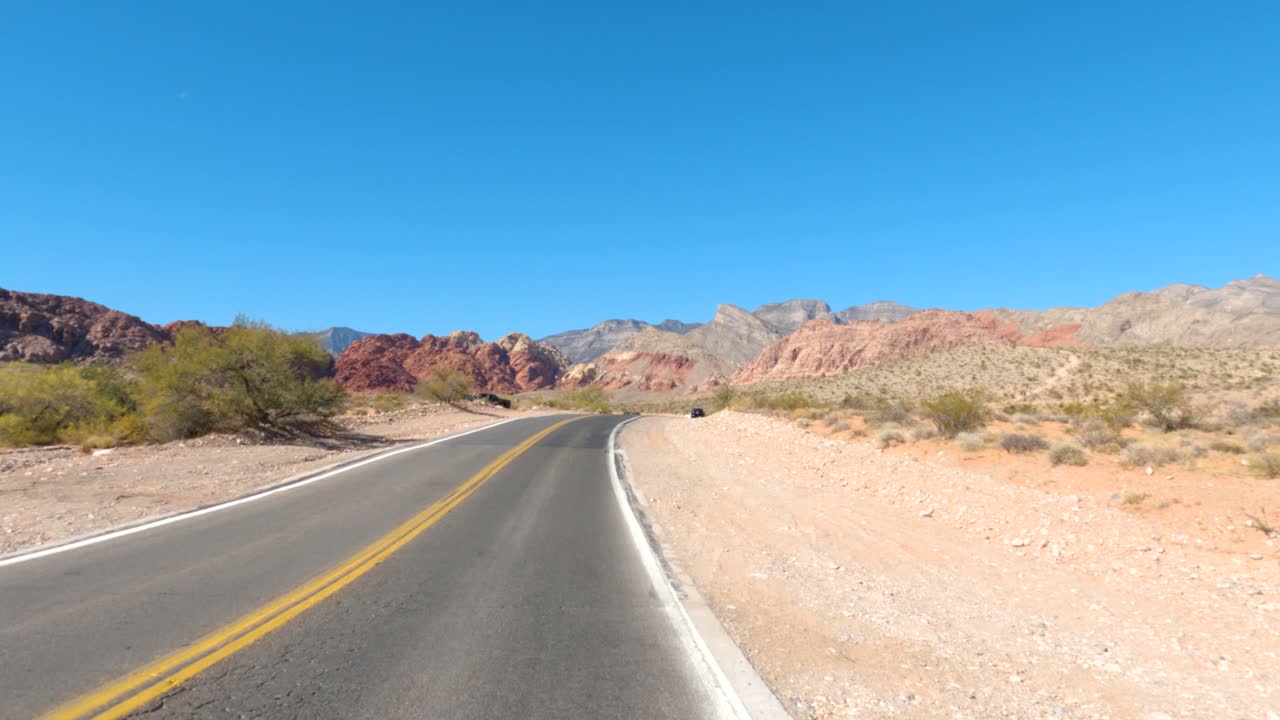 Cars Driving Down A Desert Road