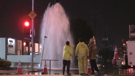 firemen try to shut of a broken water main in los angeles 7