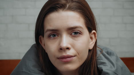 woman looking sad in bed