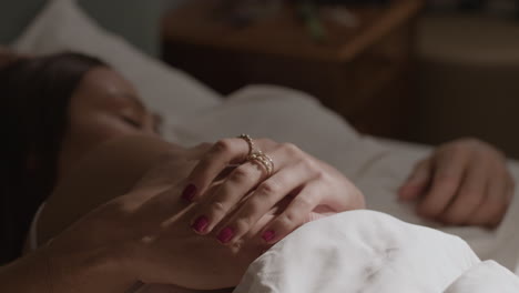 couple holding hands in bed