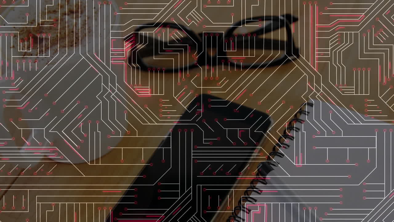 Black smartphone face-down on wooden desk showing circuit-board overlay with notebook glasses