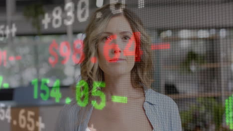 animation of financial data processing over caucasian businesswoman working in office