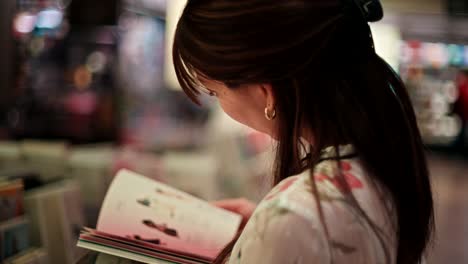 woman reading a magazine in a bookstore