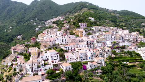 Toma-Aérea-Panorámica-A-La-Derecha-De-Un-Pueblo-Italiano-En-La-Costa-De-Amalfi,-En-Un-Paisaje-Montañoso