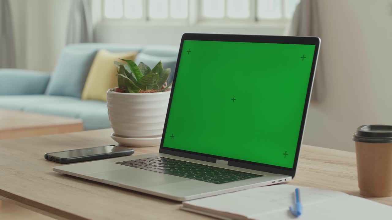 Laptop With Green Screen Display On The Table In Living Room, Video In 4K