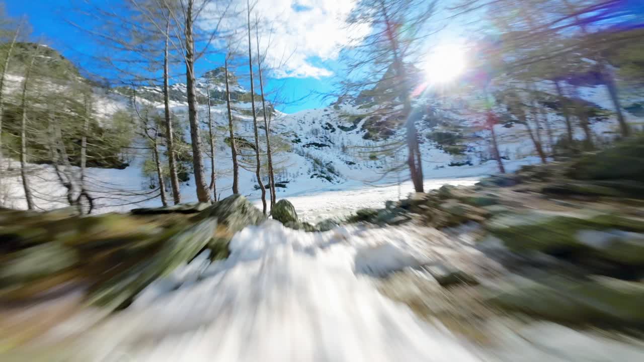 Man running on snow toward Lagazzuolo iced lake during winter season, Valmalenco in Italy