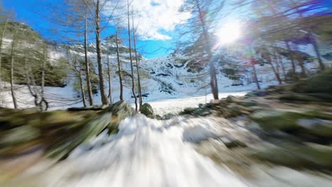 Man-running-on-snow-toward-Lagazzuolo-iced-lake-during-winter-season,-Valmalenco-in-Italy