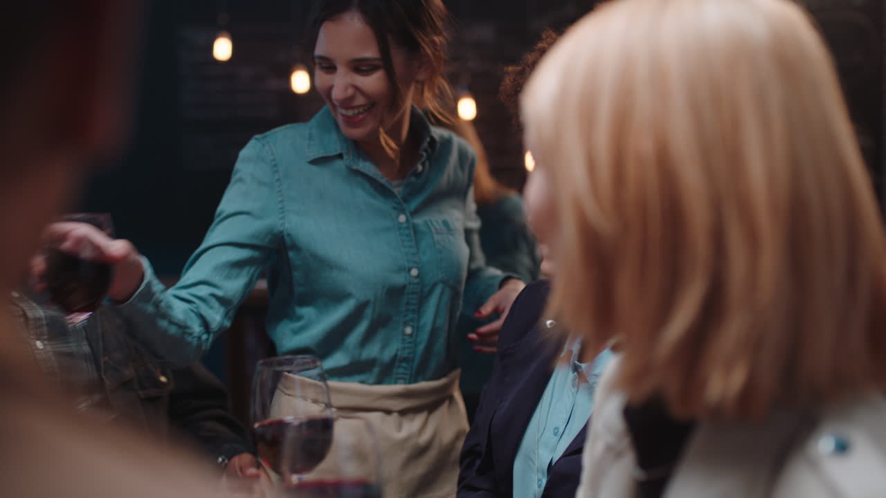 diverse group of friends making toast drinking wine having fun socializing hanging out in restaurant chatting sharing celebration enjoying evening reunion gathering