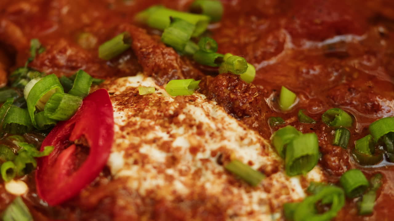 Close-up of a flavorful Indian curry dish with yogurt and spices