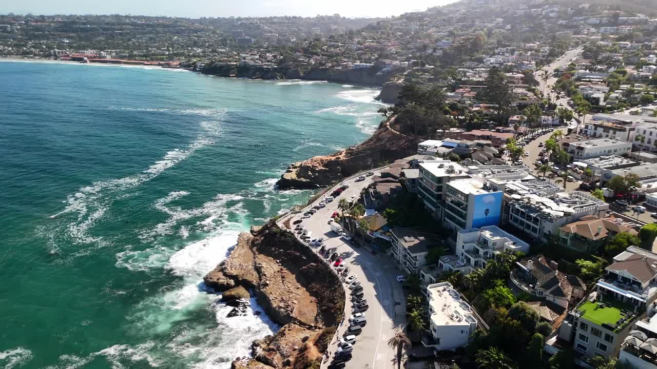 Drone footage highlighting oceanfront homes along the scenic coastline