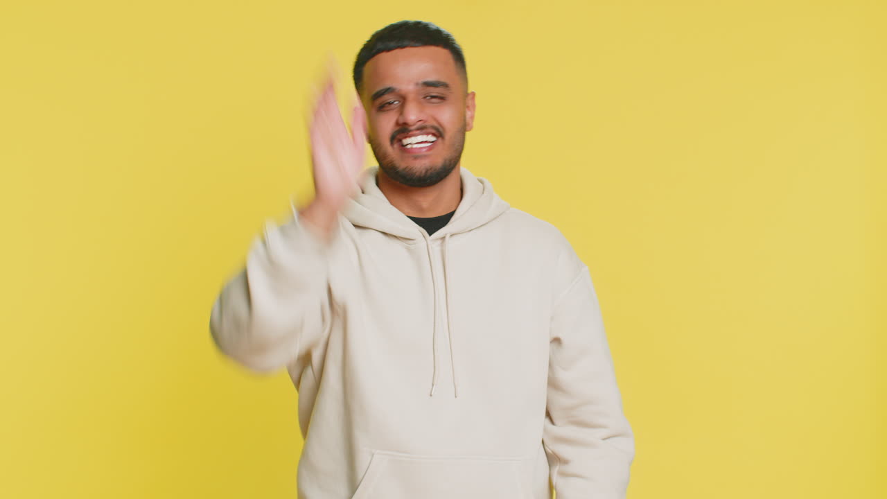 Happy man smiling friendly waving hands gesturing hello greeting or goodbye meeting invitation