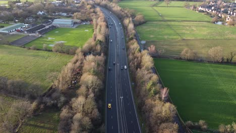 Static-aerial-drone-clip-of-a-highway-with-cars-passing-in-Manchester,-UK