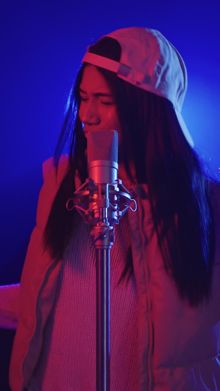 Woman singing into a microphone