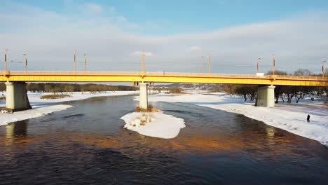 Side-low-angle-shot-of-Kaunas-Vilijampole-bridge-during-winter