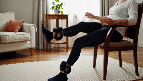 senior woman doing leg exercises in a chair
