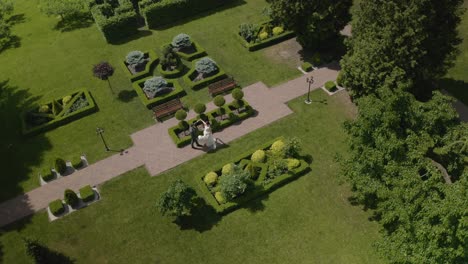 lovely newlyweds caucasian bride groom dancing in park, making kiss, wedding couple family