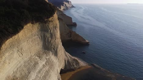 lonely boat standing in front of huge cliffs