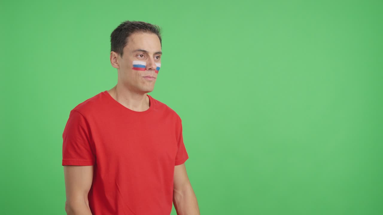 Happy man with russian flag painted on face looking away