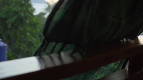 Hanging-dress-over-balcony-with-tropical-island-in-the-distance