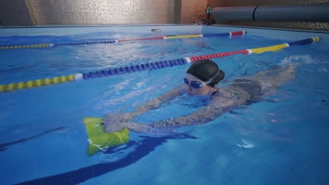 sporty young woman swimming in pool