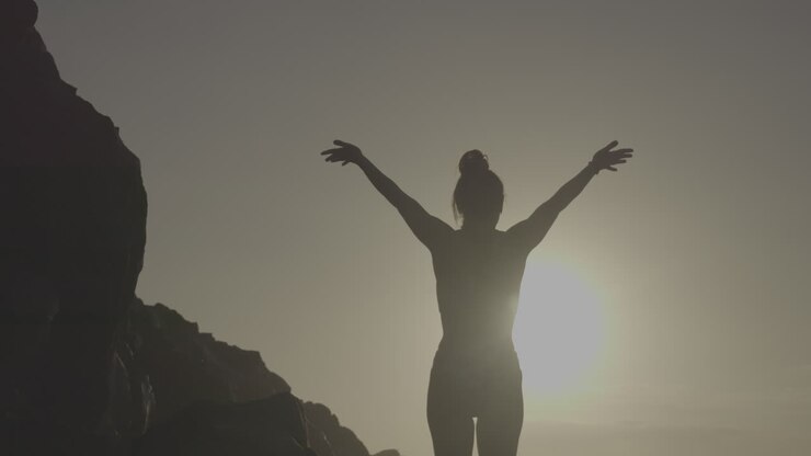 Woman enjoying a sunrise at the beach