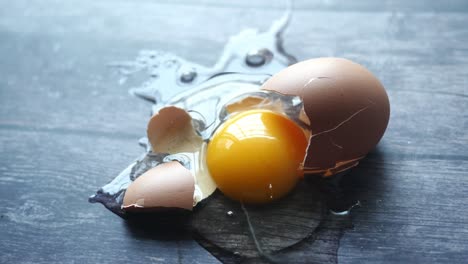 broken egg on wooden surface