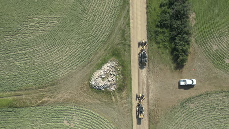 top down aerial, two road graders build new farmland road in rural countryside saskatchewan, canada