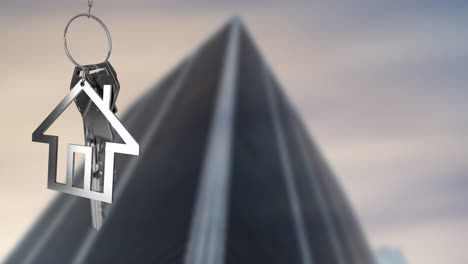 animation of silver key and house over blurred tall building