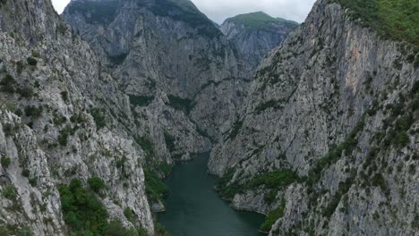 lake komani surrounded by steep mountain cliffs, showcasing nature's beauty, aerial view