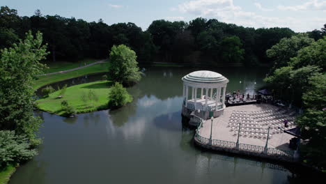 aerial flyover video of the bandstand in roger williams park during preparation for a concert