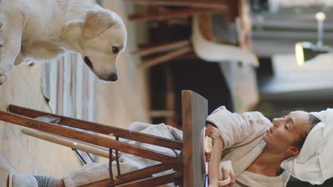 woman and dog enjoying breakfast at home