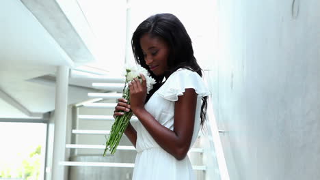 Woman-smelling-bouquet-of-flowers-and-smiling