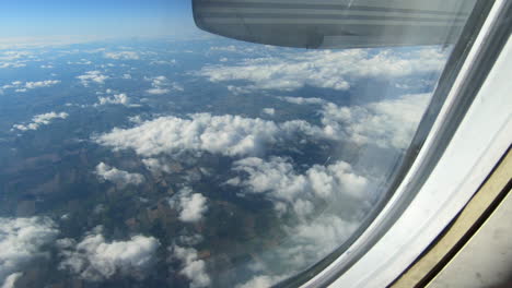 through airplane window view, aircraft window, hublot, during flight airplane seat view, aerial clouds and sky view