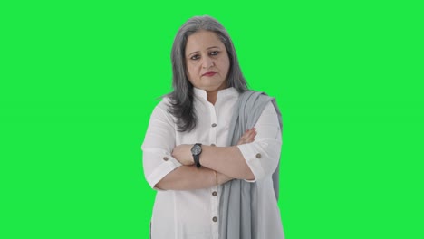 Confident-Indian-senior-businesswoman-standing-crossed-hands-Green-screen