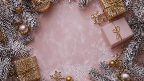 christmas decorations and gifts on a pink background