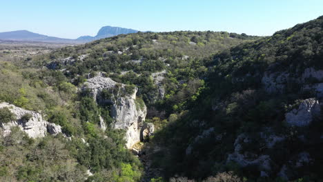 natural arch carved by the river in limestone mountain ravin des arcs