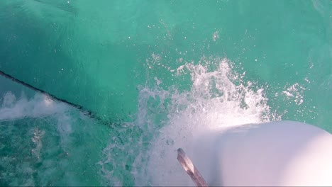 Close-up-on-front-of-sailing-boat-going-fast-with-water-splashing-up-on-fore