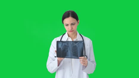 indian female doctor checking x ray green screen