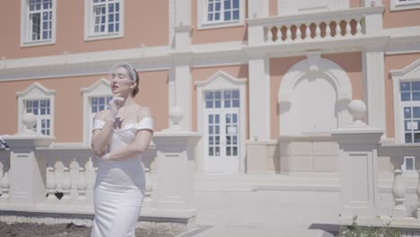 elegant bride in front of a beautiful mansion