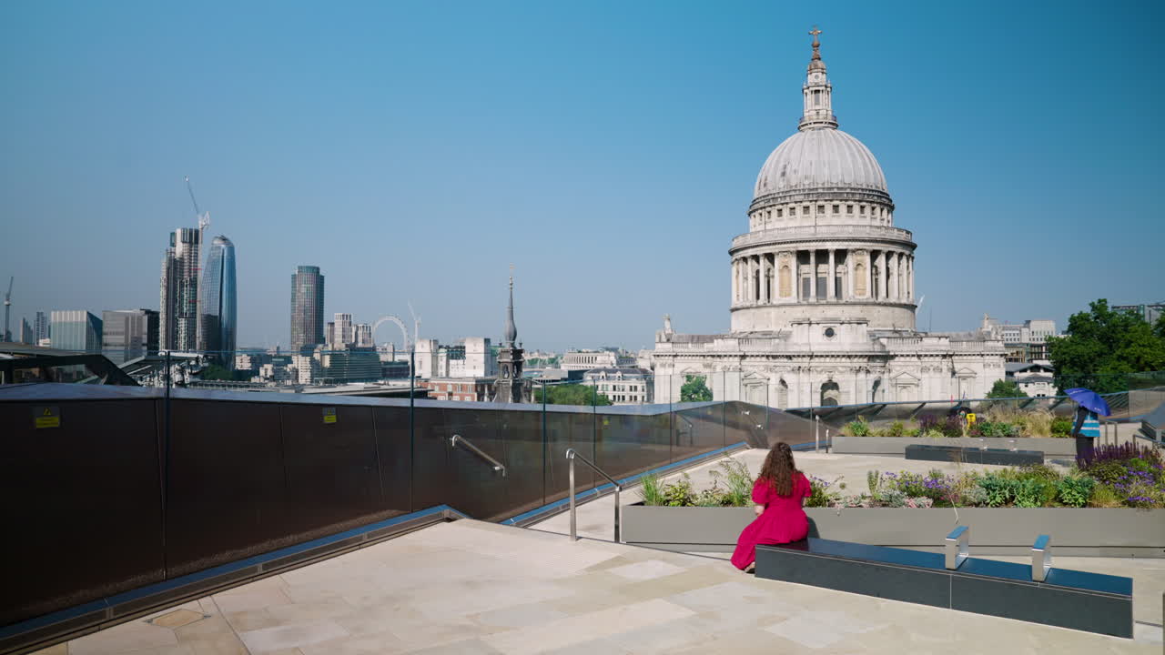 A View Of St. Paul's Cathedral Dome With A Woman In A Red Dress In London, England, UK. Static Shot