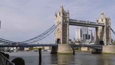 Panning-left-to-right-on-Tower-Bridge-on-a-sunny-day-in-central-London-with-car-traffic-and-tourist