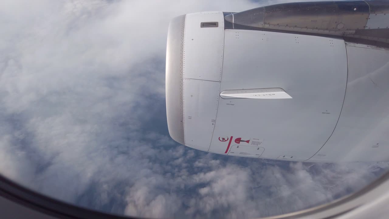 Airplane jet engine viewed out the window during flight