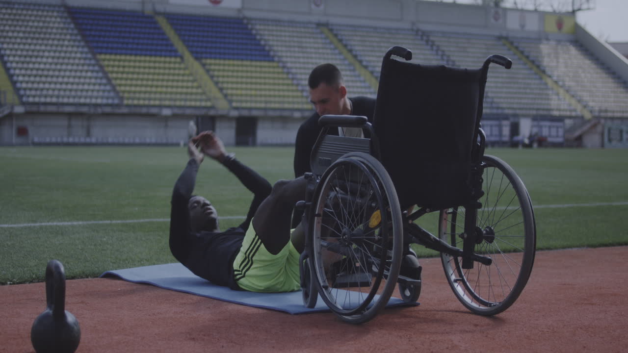 Disabled Athlete Working Out with a Trainer in a Stadium