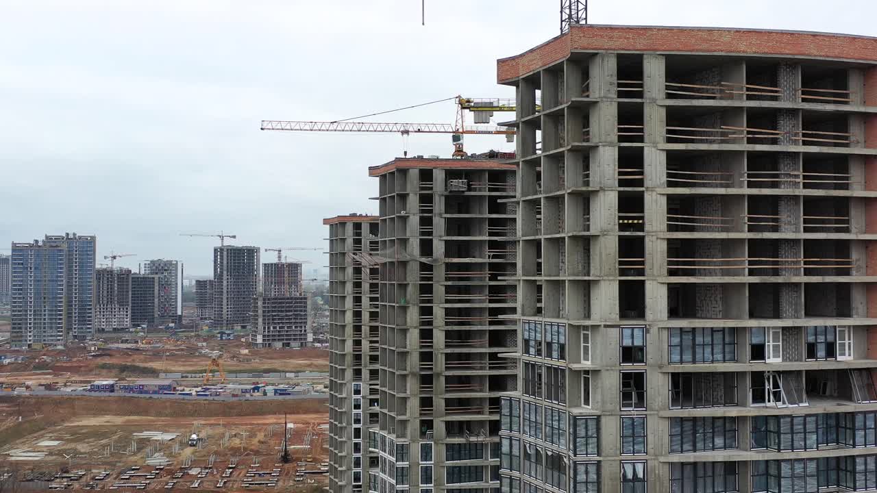 Aerial view of a large construction site with multiple high-rise buildings and cranes