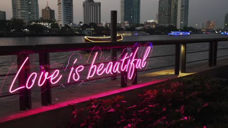 a beautiful and inspiring pink neon sign with the message &quot;love is beautiful&quot;, spreading positivity and love to all who see it