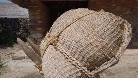 Straw-Bag-On-Jige,-Traditional-Korean-Farming-Tool-To-Lift-Luggage,-Standing-Outdoor-In-Naganeupsong-Folk-Village,-Suncheon,-South-Korea