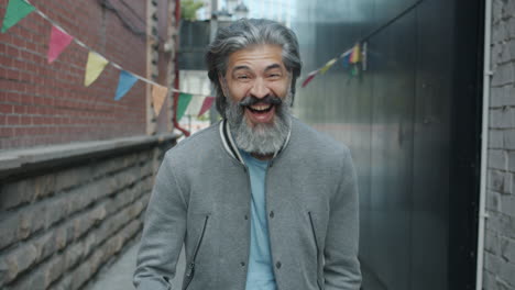 smiling senior man in an alley