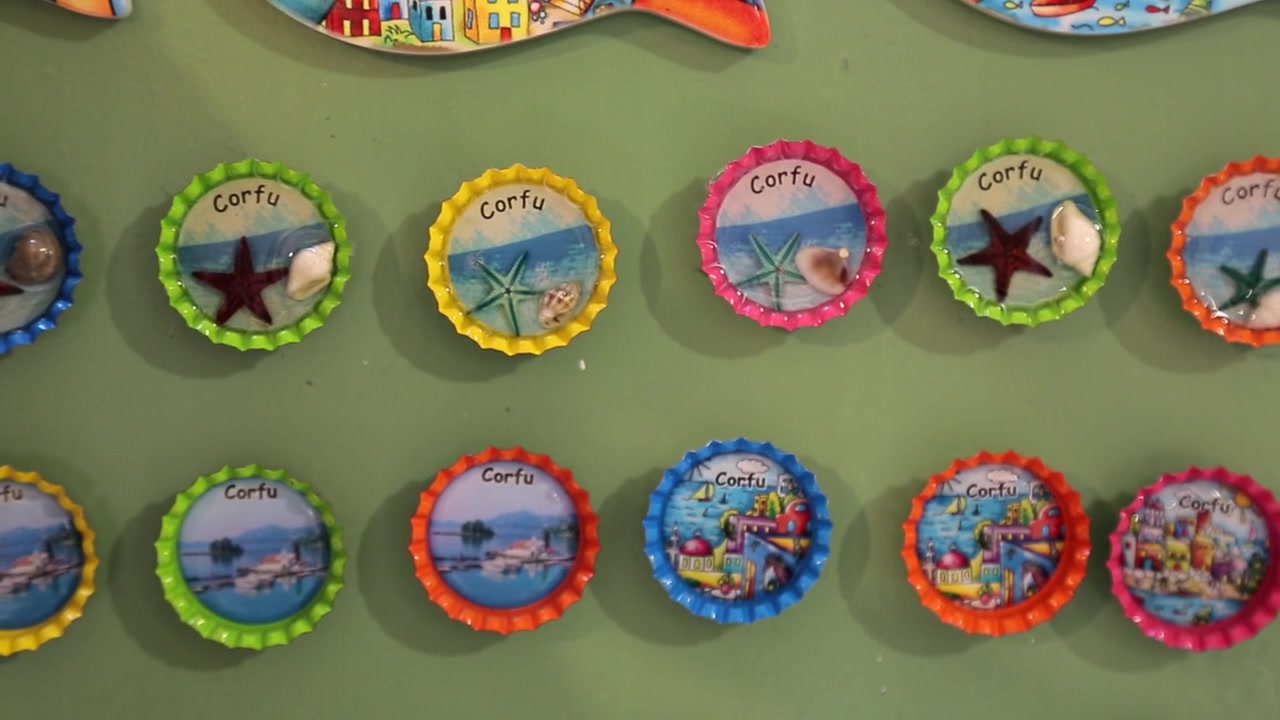 Creative Bottle Cap Souvenirs Magnets display with inspired designs and art from Corfu Island, Greece