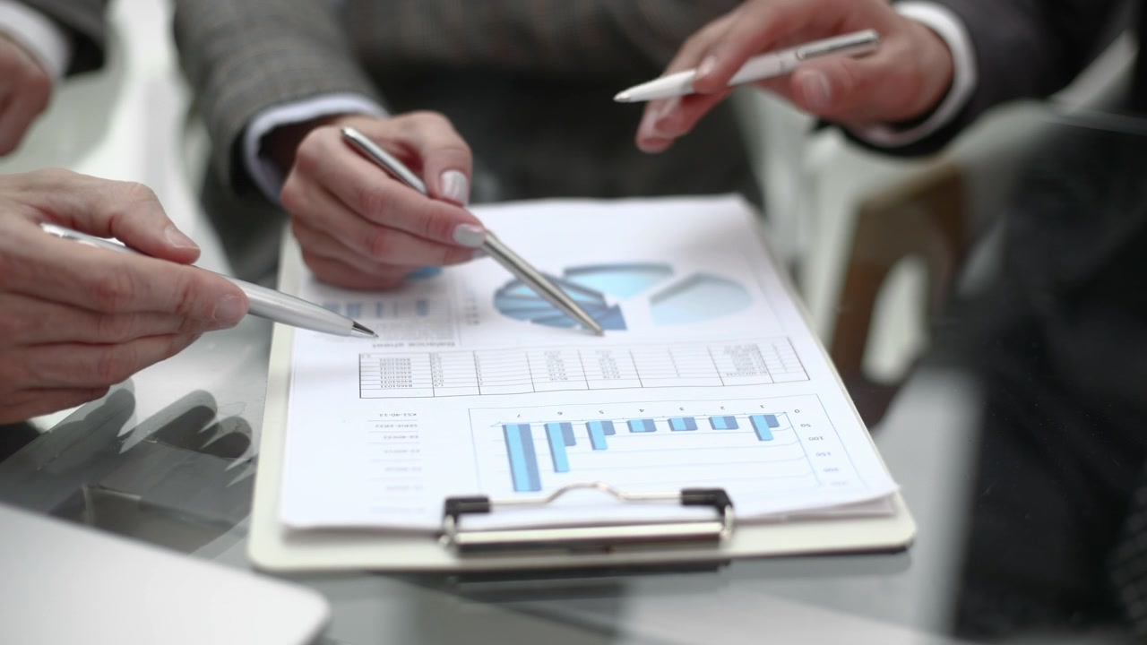 Business Professionals Analyzing Financial Data and Charts